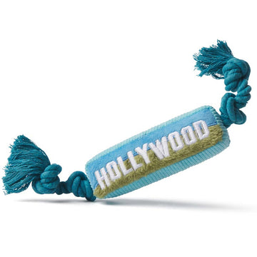 A plush pet toy in the shape of a blue and beige tube with 'Hollywood' written on it, attached to a blue rope.